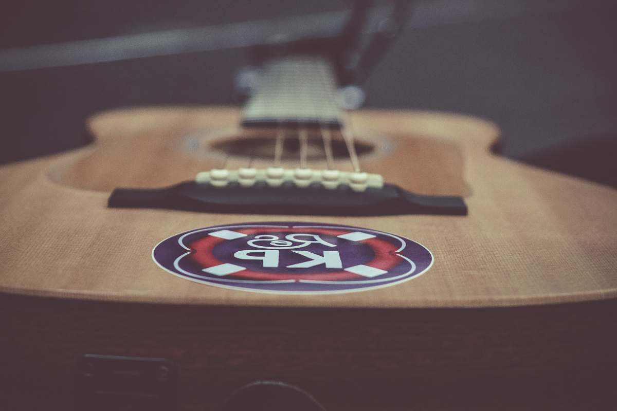 leisure activities selective focus photography of acoustic guitar electric guitar